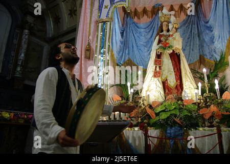 April 22, 2022, Pagani, Campania/Salerno, Italy: Pagani, Salerno, Italy - April 22, 2022 :Musicians seen sing, play tammorra and guitar during feast of Santa Maria Incoronata del Carmine called ''delle Galline''.It is a religious and civil event that takes place annually in Pagani (Salerno) from Friday of the eighth of Easter to the following Monday. The festival, celebrated in the homonymous sanctuary, is organized by the Carmelite Fathers of the sanctuary itself and by the Archconfraternity of the Madonna delle Galline. Tradition tells of a painting depicting the image of the Madonna, found Stock Photo