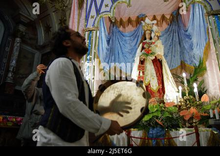 April 22, 2022, Pagani, Campania/Salerno, Italy: Pagani, Salerno, Italy - April 22, 2022 :Musicians seen sing, play tammorra and guitar during feast of Santa Maria Incoronata del Carmine called ''delle Galline''.It is a religious and civil event that takes place annually in Pagani (Salerno) from Friday of the eighth of Easter to the following Monday. The festival, celebrated in the homonymous sanctuary, is organized by the Carmelite Fathers of the sanctuary itself and by the Archconfraternity of the Madonna delle Galline. Tradition tells of a painting depicting the image of the Madonna, found Stock Photo