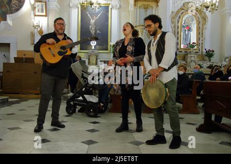 April 22, 2022, Pagani, Campania/Salerno, Italy: Pagani, Salerno, Italy - April 22, 2022 :Musicians seen sing, play tammorra and guitar during feast of Santa Maria Incoronata del Carmine called ''delle Galline''.It is a religious and civil event that takes place annually in Pagani (Salerno) from Friday of the eighth of Easter to the following Monday. The festival, celebrated in the homonymous sanctuary, is organized by the Carmelite Fathers of the sanctuary itself and by the Archconfraternity of the Madonna delle Galline. Tradition tells of a painting depicting the image of the Madonna, found Stock Photo