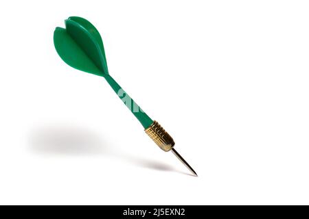 Close up of green plastic dart arrow with pointed metal tip on white background Stock Photo