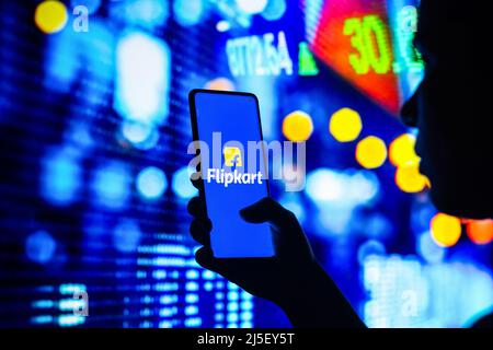 Brazil. 22nd Apr, 2022. In this photo illustration, a silhouetted woman holds a smartphone with the FlipKart logo displayed on the screen. (Photo by Rafael Henrique/SOPA Images/Sipa USA) Credit: Sipa USA/Alamy Live News Stock Photo