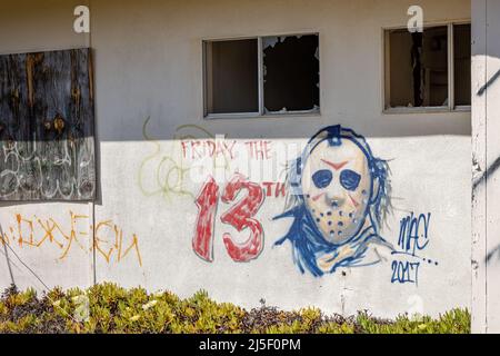 Creepy graffiti showcasing urban decay on an abandoned house Stock Photo