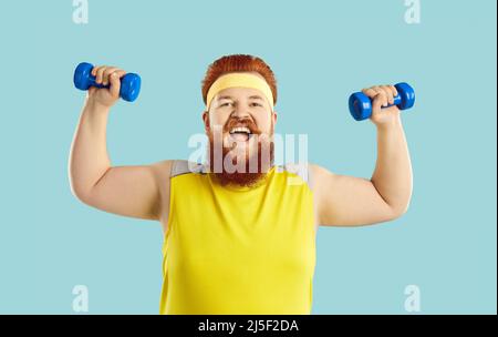 Funny happy bearded fat man having sports workout and doing exercise with dumbbells Stock Photo