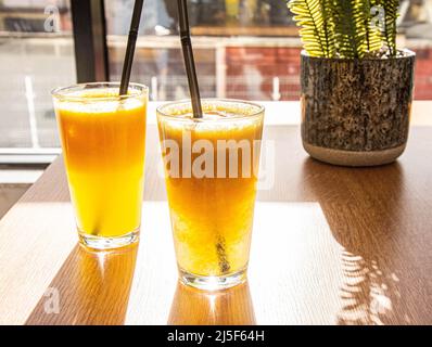 orange or apple fresh on a sunny table healthy summer refreshment Stock Photo