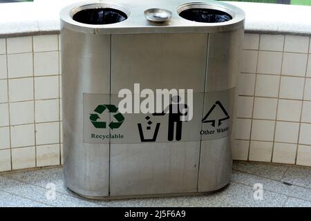 Recyclable and other wastes in a stainless steel metal trash bin for different garbage, Separation and sorting of rubbish, Container for sorting diffe Stock Photo