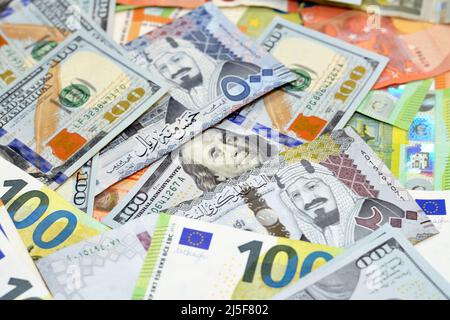 Saudi riyals money with American dollars bills and European euros banknotes, a pile of 200 and 500 Saudi Arabia riyals, 100 one hundred dollars and 10 Stock Photo