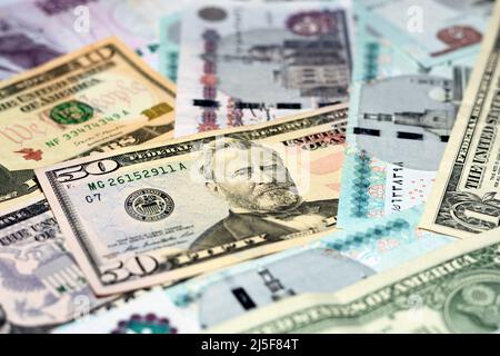 Pile of 5, 10, 20 and 50 LE five, ten, twenty and fifty Egyptian pounds money banknotes and 1, 5, 10 and 50 $ one, five, ten and fifty American dollar Stock Photo