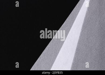 Abstract geometric felt texture background. White, gray, black colors felt textile for craft. Top view, flat lay Stock Photo