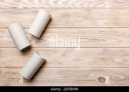 Flat lay composition with empty toilet paper rolls and space for text