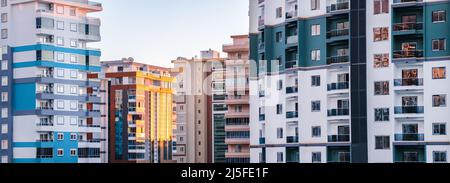 Fragments of facades of modern multi-storey residential buildings, side view, close-up. Banner Stock Photo