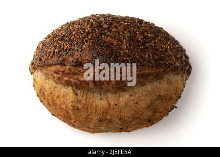 top view of fresh homemade bread with golden crispy crust on white background, organic loaf with sunflower and linen seeds close-up Stock Photo