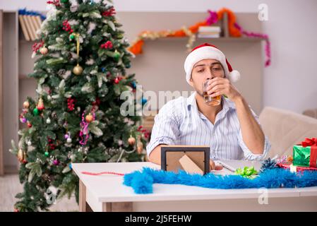 Young man celebrating New year at home alone Stock Photo