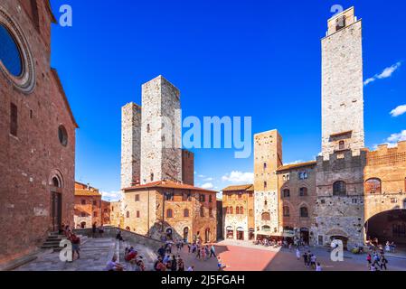 San Gimignano, Italy - September 2021. Tourists in Piazza del Duomo, San Gimignano (Italy) the famous small walled medieval hill town in the province Stock Photo