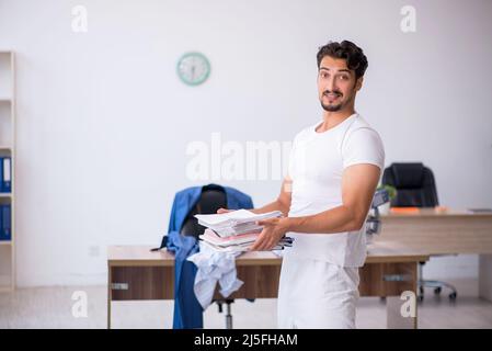 Young businessman employee doing sport exercises at workplace Stock Photo