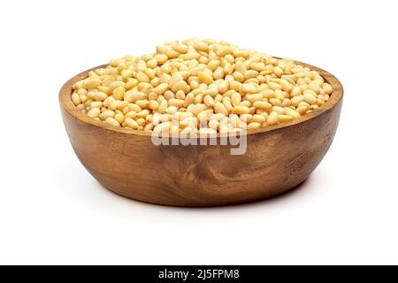 Wooden bowl with peeled pine nuts isolated on white background. Stock Photo