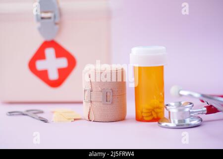 first aid kit box and medical pill on table  Stock Photo