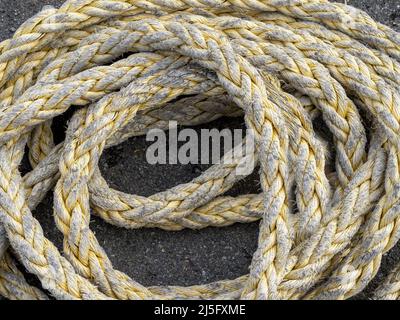 Closeup of fishing rope coiled on a quayside Stock Photo