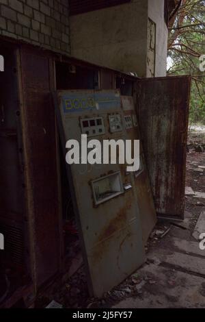 PRIPYAT, UKRAINE - May 11, 2019: Rusty vending machines for sale soda water near cafe in dead abandoned ghost town of Pripyat, Chernobyl NPP exclusion Stock Photo