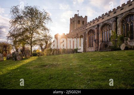 Sun setting over the Anglican Church of St. Peter ad Vincula in the Essex village of Coggeshall. Stock Photo