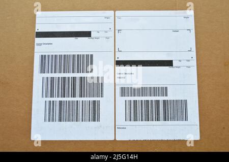 Brown and beige cardboard paper mail envelope on sticky barcodes. Can be used in company correspondence Stock Photo