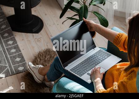 Young woman using laptop to work home, remote work Stock Photo
