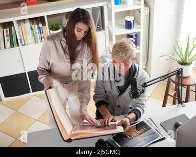 photographers working with laptop at the working place with two computers in the studio Stock Photo