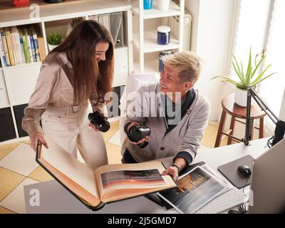 photographers working with laptop at the working place with two computers in the studio Stock Photo