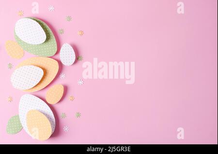 Easter background. Easter decorative eggs made of colored polka dot paper on a pink background, selective focus Stock Photo