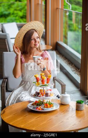 Tea with selection of various desserts in luxury restaurant with sea view Stock Photo