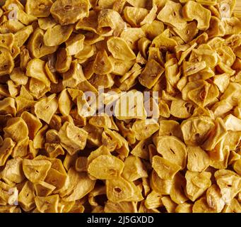 Aromatic dry garlic flakes. Background, close-up, top view. Stock Photo