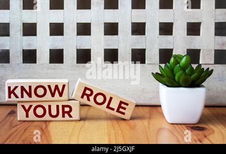 Three wooden blocks with the words KNOW YOUR ROLE. Stock Photo