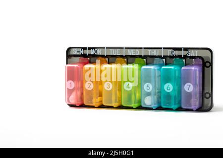 pill dispenser opened and loose pills isolated on a white background Stock Photo