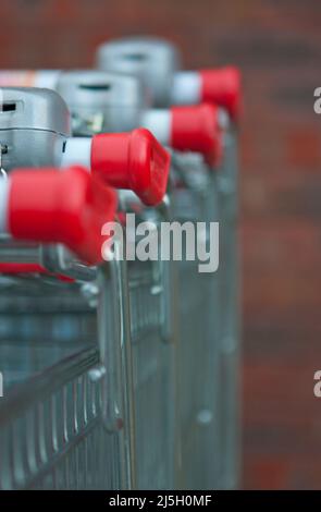 red shopping trolleys stacked together selective focus Stock Photo
