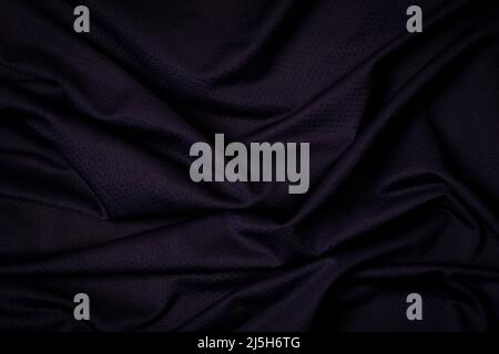 Sport clothing fabric texture background. Navy blue fabric sport clothing football jersey with air mesh texture background. Top view Stock Photo