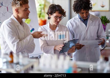 Young medical workers working together in lab Stock Photo