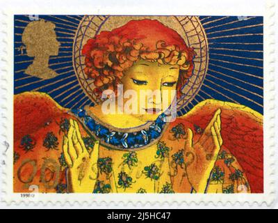 Photo of a British Christmas postage stamp with an illustration of a Christmas angel 1998 Stock Photo