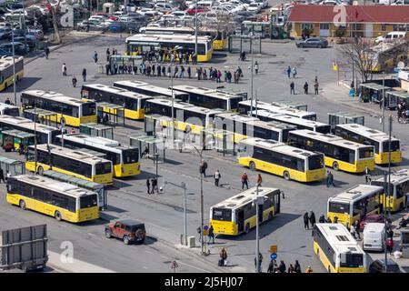 High angle aerial zoomed view of Eminonu municipal bus station and passangers waiting on the coast of the Golden Horn in Istanbul, Turkey. Stock Photo