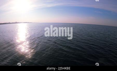 View coastline with houses and hotels from motor boat in sea while moving Stock Photo