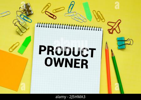 PRODUCT OWNER . Text written on the notepad with office tools and documents Stock Photo