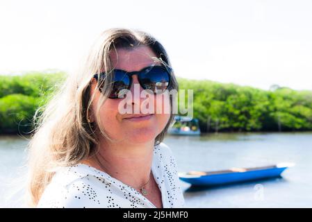 Portrait of a Caucasian woman looking at the camera against the street as a background. Aratuipe, Bahia, Brazil. Stock Photo