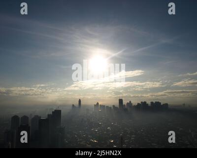 manila skyscraper Philippines skyscraper buildings with sun and misty clouds Stock Photo