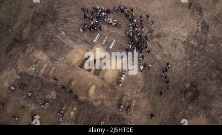 Borodyanka, Ukraine. 23rd Apr, 2022. Friends and family attend funeral services for Mark Bobrovytsky, 59, Halyna Bobrovytskyi, 59, and Maksym Bobrovytsky, 25 at a cemetery in Borodyanka, Ukriane They died in they apartment in Borodyanka after a Russian air strike. A planned evacuation of civilians in the besieged southern city of Mariupol on Saturday was again thwarted by the Russian military, according to Ukrainian leaders. Photo by Ken Cedeno/UPI Credit: UPI/Alamy Live News Stock Photo