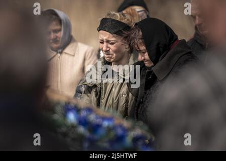 Borodyanka, Ukraine. 23rd Apr, 2022. Friends and family attend funeral services for Mark Bobrovytsky, 59, Halyna Bobrovytskyi, 59, and Maksym Bobrovytsky, 25 at a cemetery in Borodyanka, Ukriane on Saturday, April 23, 2022. They died in they apartment in Borodyanka after a Russian air strike. A planned evacuation of civilians in the besieged southern city of Mariupol on Saturday was again thwarted by the Russian military, according to Ukrainian leaders. Photo by Ken Cedeno/UPI Credit: UPI/Alamy Live News Stock Photo