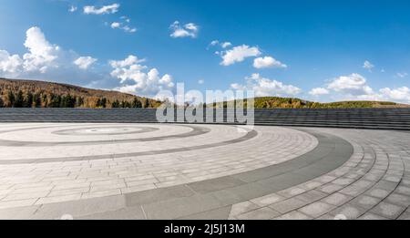 Empty square floor and mountains under blue sky Stock Photo