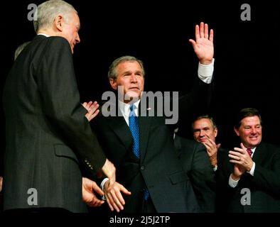 United States President George W. Bush (C), acknowledges applause during a signing ceremony of a new Medicare legislation December 8, 2003 at the DAR Constitution Hall in Washington, DC. President Bush signed into law a new $400 billion Medicare plan that adds prescription drug coverage to America's seniors. US Senator Orrin Hatch (Republican of Utah) (L), US Senator John Breaux (Democrat of Louisiana) (2nd R) and US House Majority Leader Tom DeLay (Republican of Texas) (R) also participated in the event. Credit: Alex Wong/Pool via CNP Stock Photo