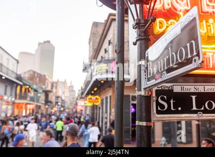New Orleans, LA - April 3, 2022: Unidentified people on Bourbon Street in the New Orleans French Quarter Stock Photo