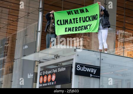 2 activists from Extinction Rebellion climbed subway station, unveiled banner on 6th Avenue after conclusion of Annual March for Science and were arrested by police. Annual March for Science which is the world's largest grassroots community of science advocates, organizing for a more sustainable and just future. Because of COVID-19 pandemic the last two years, the March for Science was virtual. March for Science takes place annually around Earth Day celebration. Activists from the Extinction Rebellion joined the march and after it ended blocked traffic along 6th Avenue and 22 members were arre Stock Photo