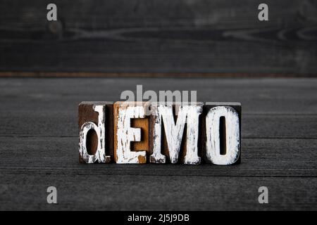 DEMO. Wooden alphabet letters on a dark textured background. Stock Photo