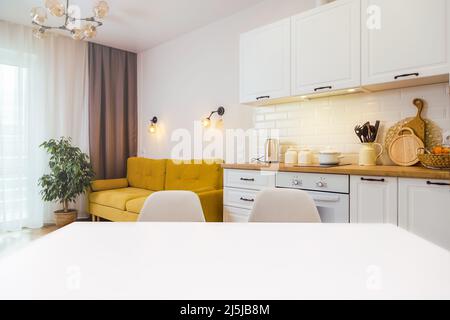 Mockup, empty table in bright kitchen interior. Copy paste for your design Stock Photo