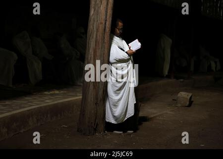 An Ethiopian Orthodox church worshiper attends an Easter eve vigil at the Bole Medhanialem church in Addis Ababa, Ethiopia, April 23, 2022. Picture taken April 23, 2022. REUTERS/Tiksa Negeri